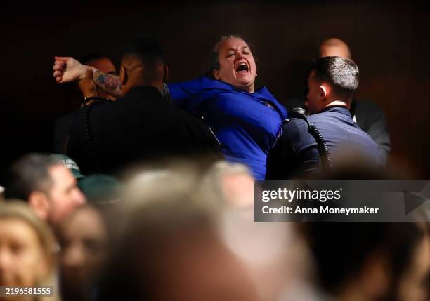 Protester is removed as Robert F. Kennedy Jr., U.S. President Donald Trump's nominee for Secretary of Health and Human Services testifies during his...