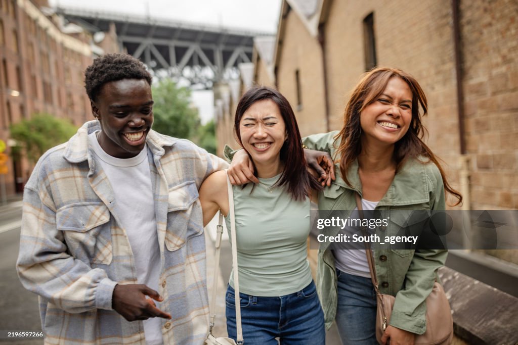 Group of friends enjoying a sunny day in Sydney, exploring the city together with smiles and laughter