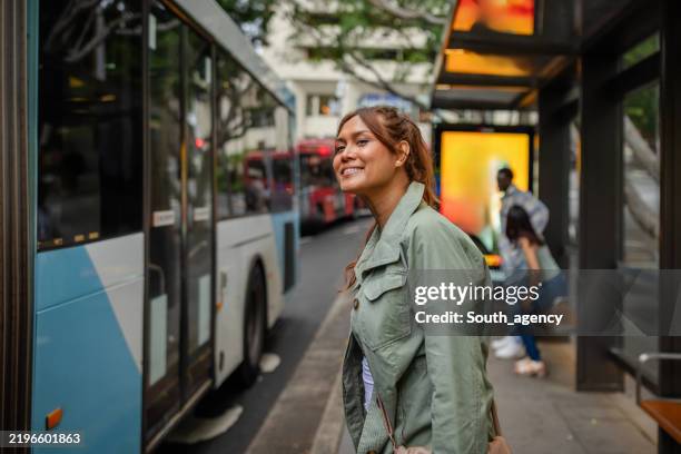 joyful young adults enjoying their time together while exploring the sights of sydney, australia on a weekend adventure - busshållplats bildbanksfoton och bilder
