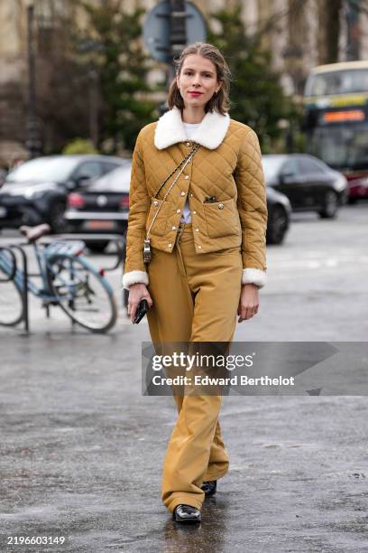 Guest wears light brown quilted Sherpa jacket, light brown slouchy pants, shiny black leather shoes, outside Chanel, during the Haute Couture...