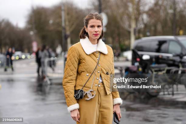 Guest wears light brown quilted Sherpa jacket, light brown slouchy pants, outside Chanel, during the Haute Couture Spring/Summer 2025 on January 28,...