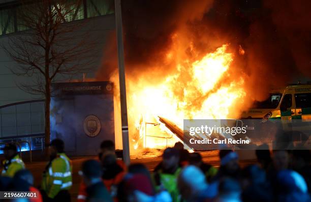 General view as a merchandise stall on the outside of the stadium is seen on fire as fans gather outside the stadium prior to the UEFA Champions...
