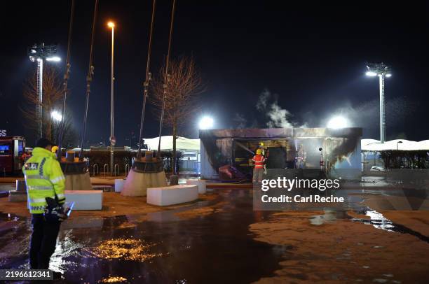 Members of the Fire Service tend to a fire at a merchandise stall on the outside of the stadium prior to the UEFA Champions League 2024/25 League...