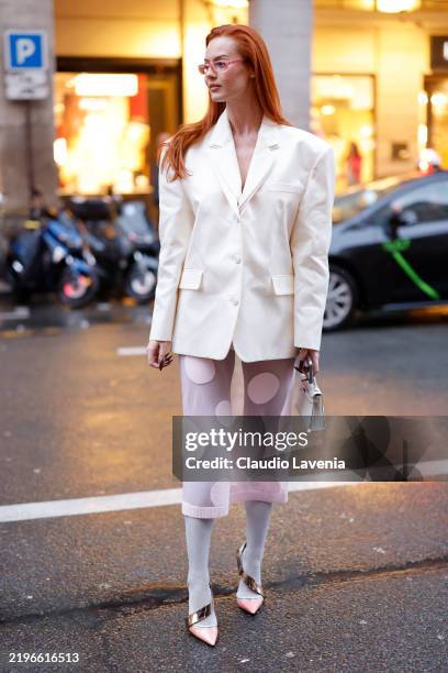Jordan Grant wears cream blazer, pink polka dot sheer midi skirt, pink tights, pink heels, white Hermès bag, outside Viktor & Rolf, during the Haute...