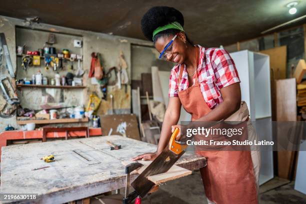 carpenter sawing a wood on a woodshop - workbench stock pictures, royalty-free photos & images