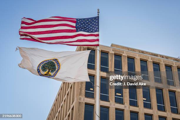 The U.S. Flag and the Department of Education flag fly above the U.S. Department of Education headquarters building on January 29 in Washington, DC.