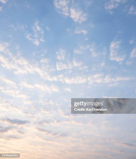 a view of fluffy clouds at sunrise - blue morning glory stock pictures, royalty-free photos & images