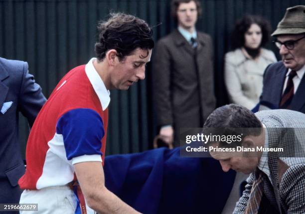 View of Prince Charles, Prince of Wales and an unidentified man during a polo match at Smiths Lawn, Windsor Great Park, Windsor, England, July 1978.
