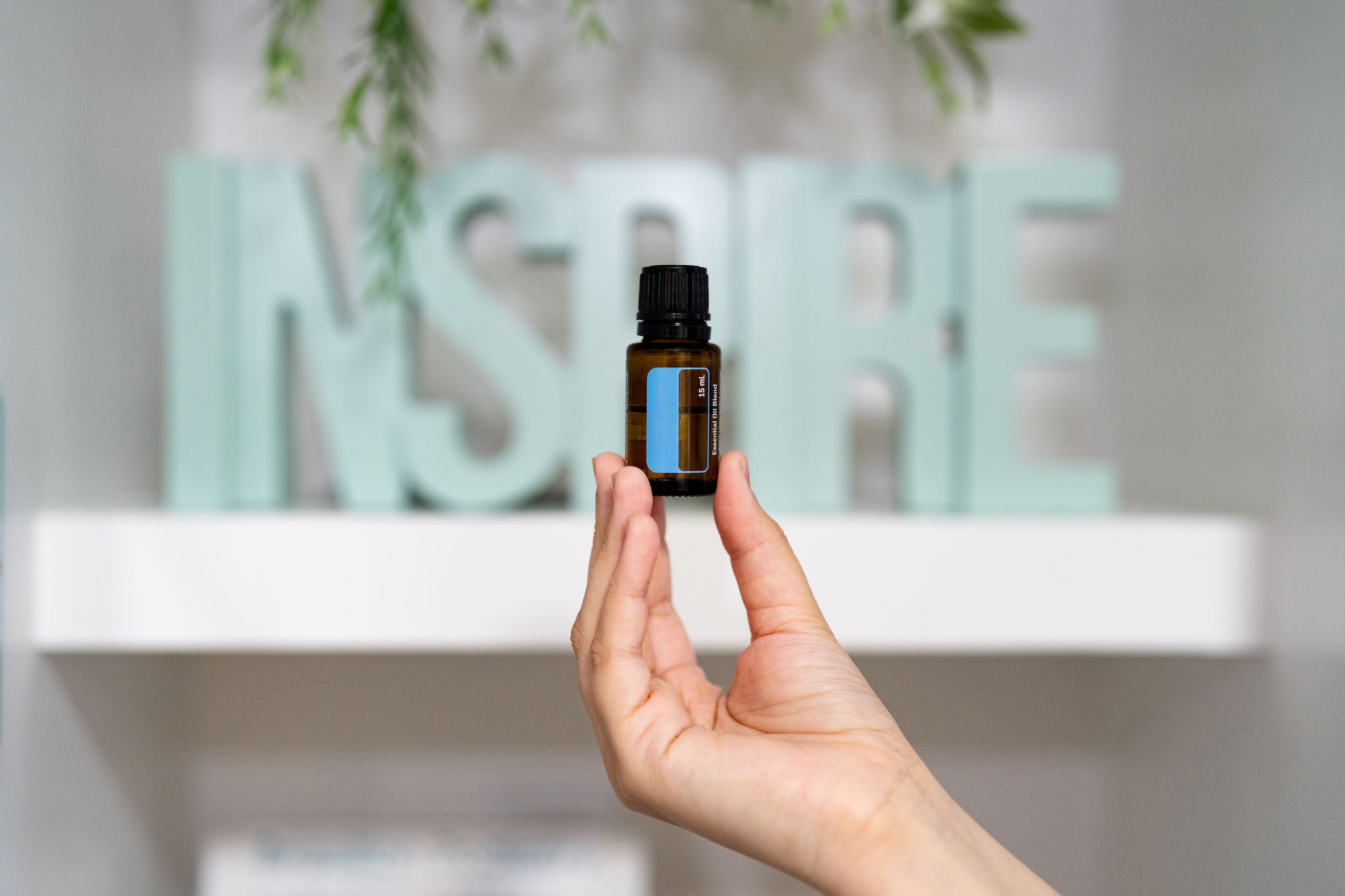 Person holding an essential oil bottle Person holding an essential oil bottle