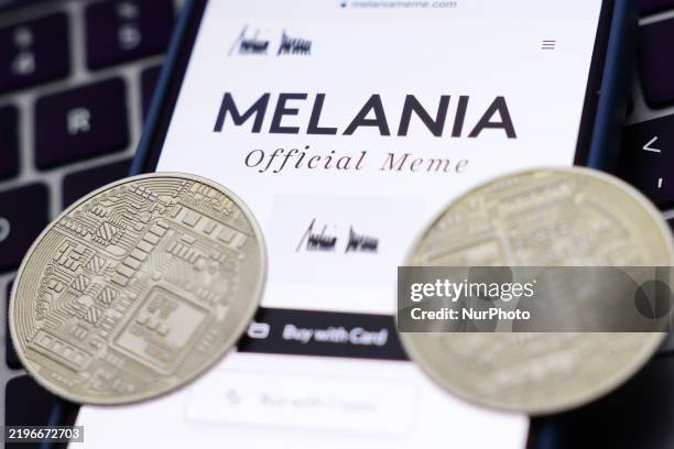 Laptop keyboard, Melania Official Meme website displayed on a phone screen and representation of cryptocurrency are seen in this illustration photo...