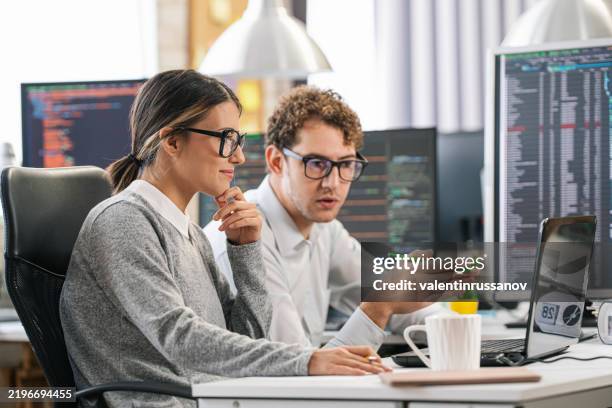 couple, software engineer developer use computer, work on program coding together at the office. programming language development technology, freelance job concept - python programming language stock pictures, royalty-free photos & images