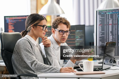 Couple, software engineer developer use computer, work on program coding together at the office. Programming language development technology, freelance job concept Couple, software engineer developer use computer, work on program coding together at the office. Programming language development technology, freelance job concept