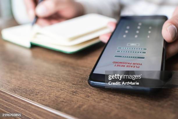 man with smartphone trying to reset his password. data security, data leaks and unauthorised access concepts. - forgot password stock pictures, royalty-free photos & images