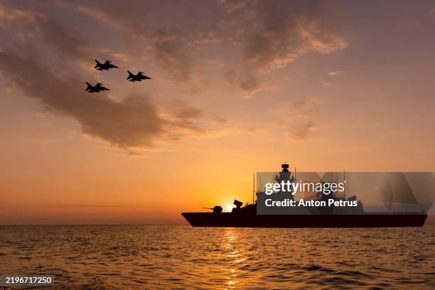 warship and fighter jets at sunset - navio de batalha imagens e fotografias de stock