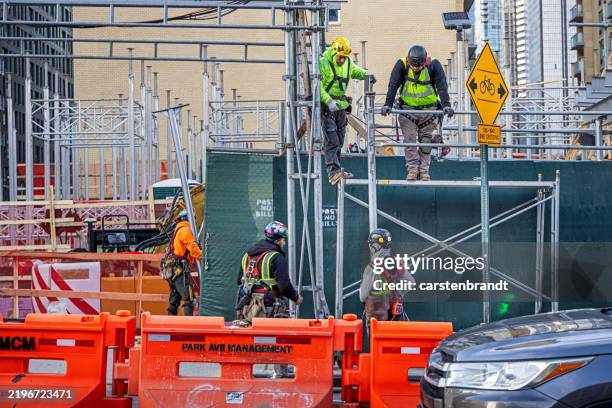 construction workers on a building site at a cold winters day - queens day stockfoto's en -beelden