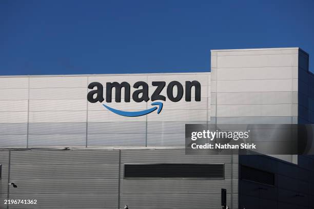 The Amazon logo is displayed outside Amazon UK MAN8 Warehouse on January 30, 2025 in Haydock, United Kingdom.