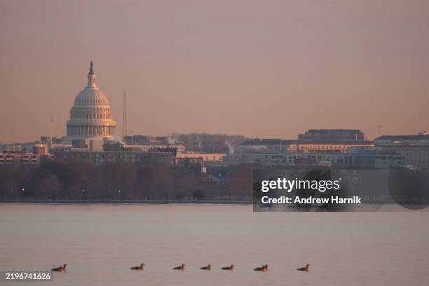 Emergency response units conduct search and rescue operation at the crash site of the American Airlines plane on the Potomac River after the plane...