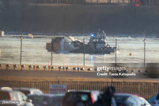 Emergency response units search the crash site of the American Airlines plane on the Potomac River after the plane crashed last night on approach to...