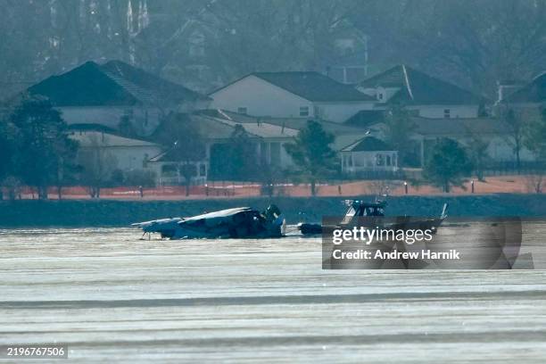 Emergency response units search the crash site of an American Airlines plane on the Potomac River after an accident last night while on approach to...