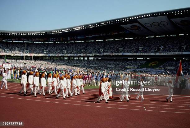 Wrestler Kartar Singh leads the team from India bearing the national flag during the Olympic Parade Of Nations at the opening ceremony for the XXIV...