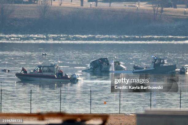 Emergency response units search the crash site of an American Airlines plane on the Potomac River after an accident last night while on approach to...