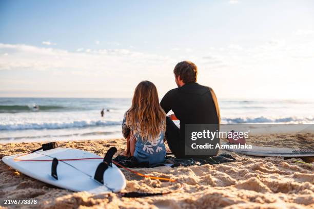 father and daughter on gold coast beach at sunrise - gold coast australia stock pictures, royalty-free photos & images