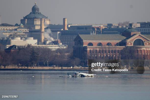 Emergency response units search the crash site of the American Airlines plane on the Potomac River after the plane crashed last night on approach to...