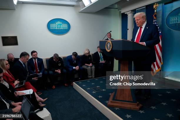 President Donald Trump takes a moment of silence before he speaks to reporters about the collision of an American Airlines flight with a military...