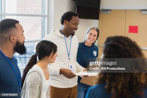 volunteers discussing community outreach at meeting - non profit organization stock pictures, royalty-free photos & images