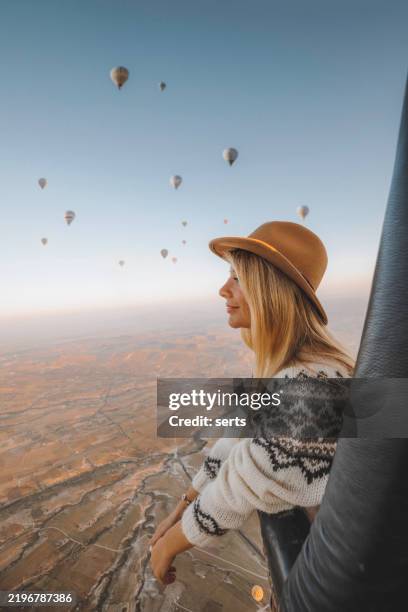 donna turista che si gode un giro in mongolfiera sulla cappadocia, turchia - mongolfiera foto e immagini stock