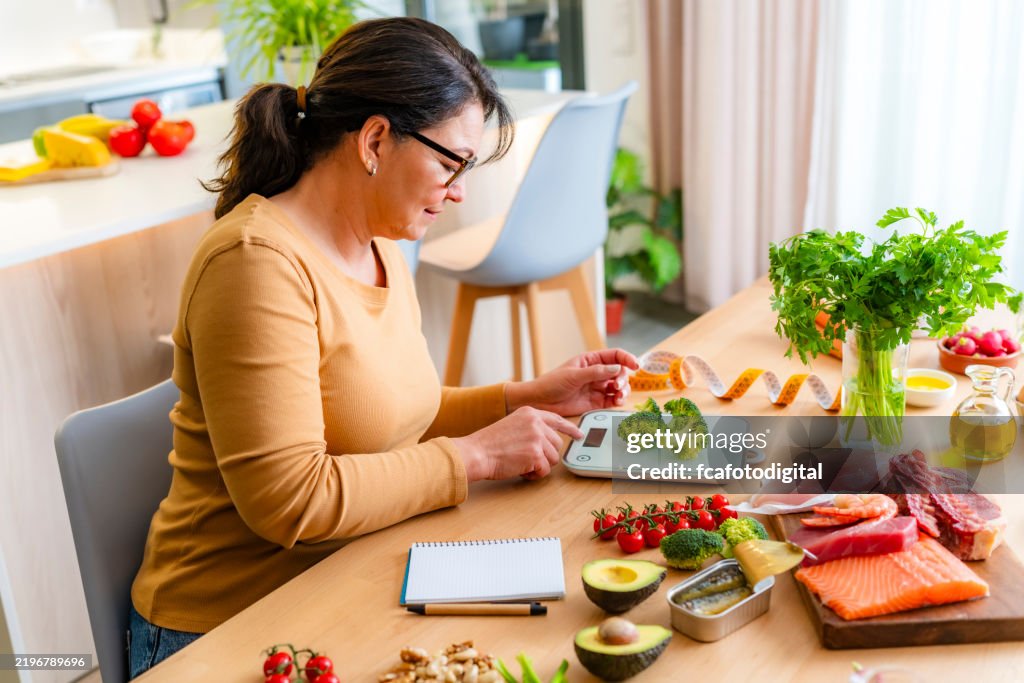 Woman using weight scale to get the proper serving size of food. Healthy eating concept
