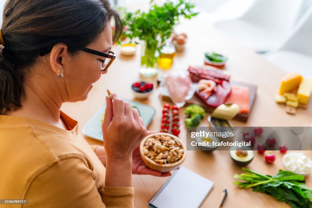 Healthy eating and dieting: woman planning a healthy low carb diet