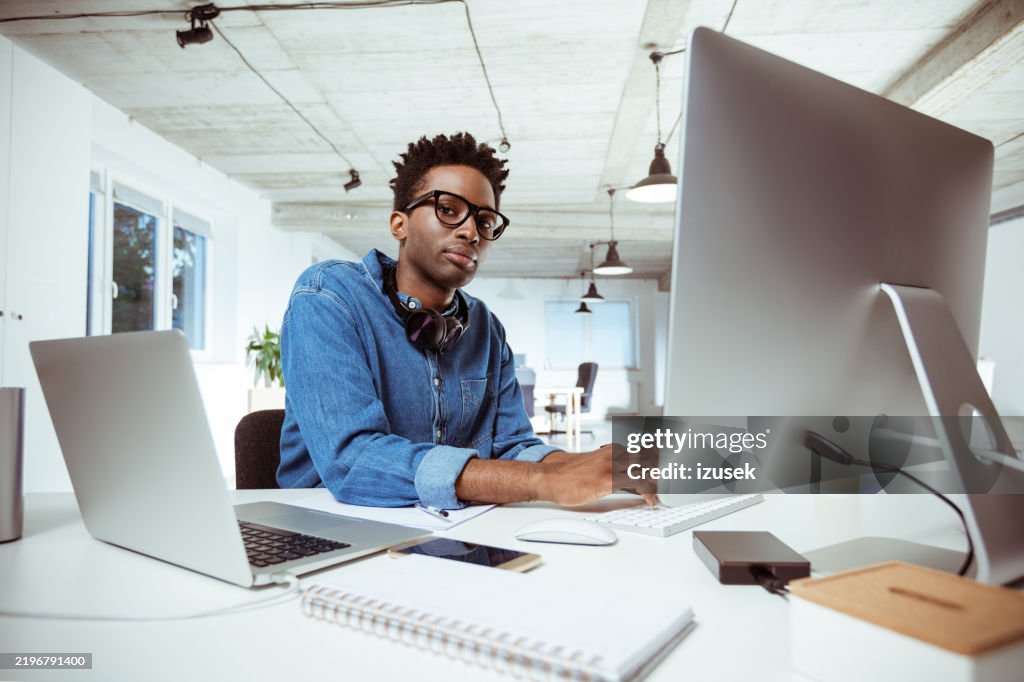 Portrait of confident businessman working at desk