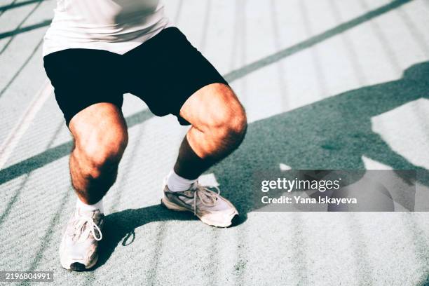 an unrecognizable male learning squat technique - pelvic floor stock pictures, royalty-free photos & images