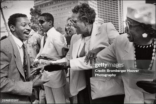 American film director & actor Robert Townsend greets fans outside an unspecified event, Oakland, California, 1987.
