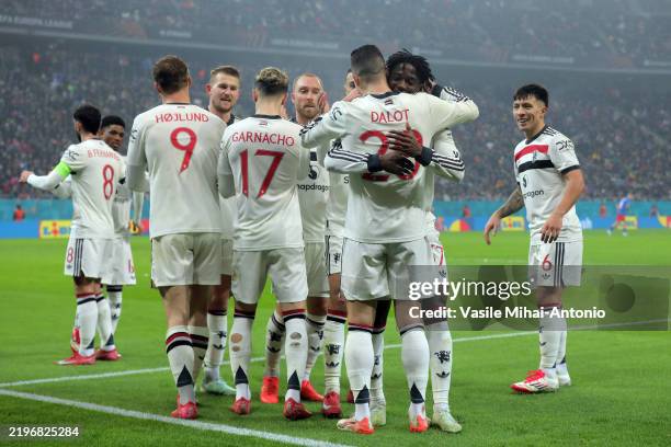 Diogo Dalot of Manchester United celebrates scoring his team's first goal with teammate Kobbie Mainoo during the UEFA Europa League 2024/25 League...