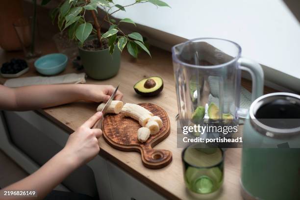 child preparing healthy smoothie in a blender - cutting avocado stock pictures, royalty-free photos & images