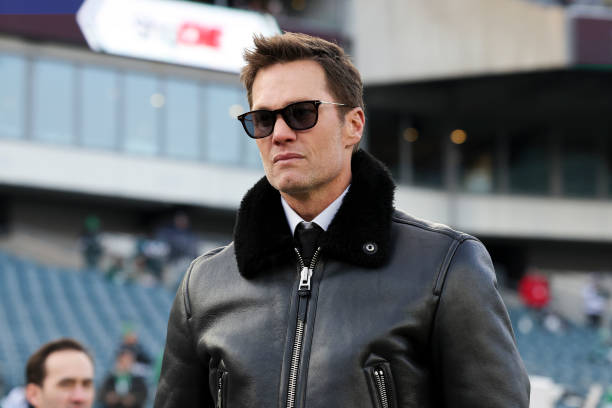 Tom Brady stands on the sidelines prior to a Wild Card Playoff Game between the Philadelphia Eagles and the Green Bay Packers at Lincoln Financial...