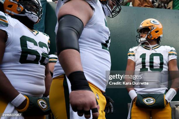 Jordan Love of the Green Bay Packers stands in the tunnel with teammates prior to a Wild Card Playoff Game against the Philadelphia Eagles at Lincoln...