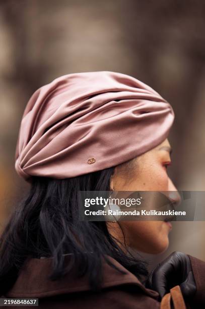 Pornwika Spiecker wears dusty pink turban and brown jacket outside the Munthe fashion show during the Copenhagen Fashion Week Autumn/Winter 2025 on...