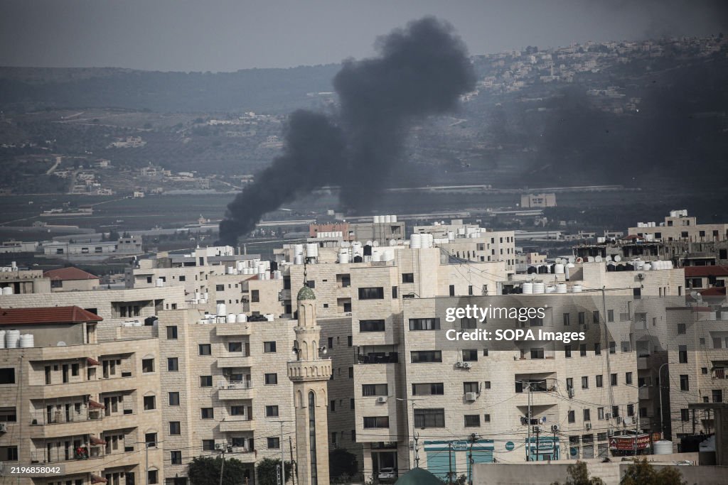 Smoke rises from a residential block belonging to...