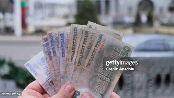 Hand holding a Transnistrian ruble is seen as daily life continues in Tiraspol, Transnistria region, which is facing a serious energy crisis due to...