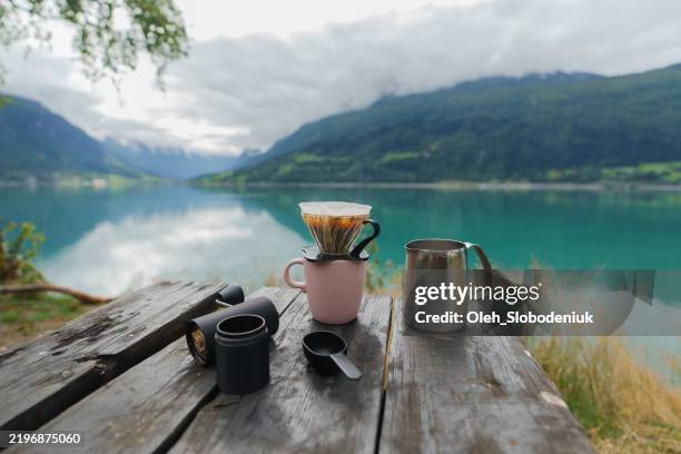 brewing freshly grounded pourover coffee on the background of the lake - lakeshore stock pictures, royalty-free photos & images