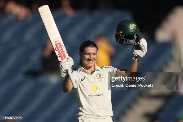 Annabel Sutherland of Australia raises her bat after making a century during day two of the Women's Ashes Test Match between Australia and England at...