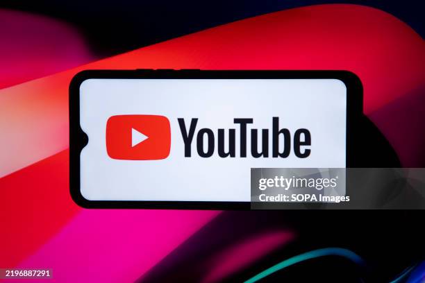 In this photo illustration, the YouTube logo is seen displayed on a mobile phone screen.
