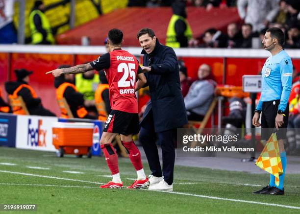 Head coach Xabi Alonso of Leverkusen talks with Exequiel Palacios of Leverkusen during the UEFA Champions League 2024/25 League Phase MD8 match...