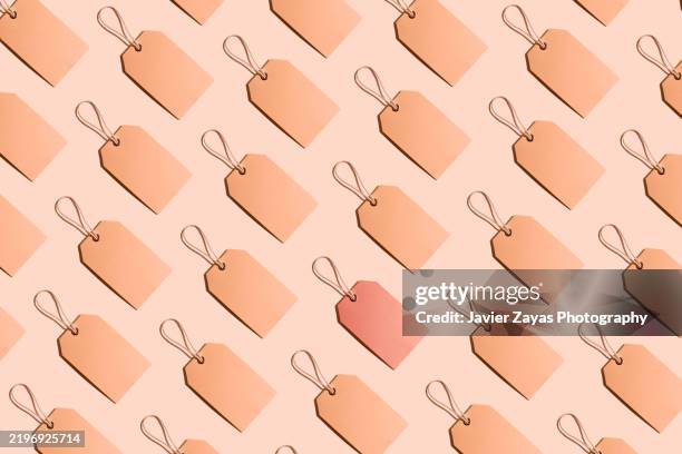 pattern of brown paper price labels with rope on a mocha mousse background, one label is red - labeling stock pictures, royalty-free photos & images