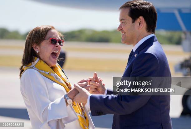 El Salvador's Foreign Minister Alexandra Hill Tinoco welcomes US Secretary of State Marco Rubio upon his arrival at El Salvador International Airport...