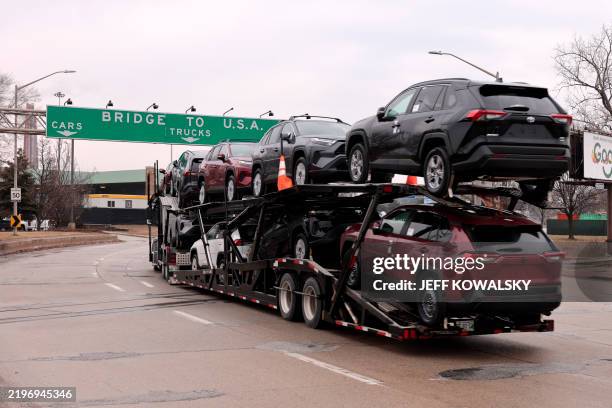 Car hauler carries Toyota RAV4 vehicles as it enters to cross the Ambassador Bridge in Windsor, Ontario to go to Detroit, Michigan on February 3,...