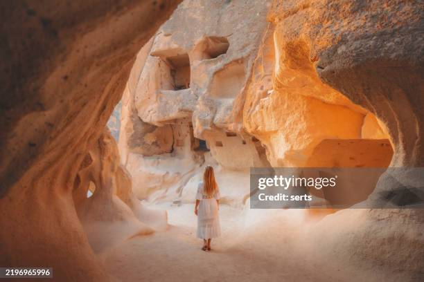 solo traveler exploring the ancient rock formations of pasabag, cappadocia, turkey - anatolien stock-fotos und bilder